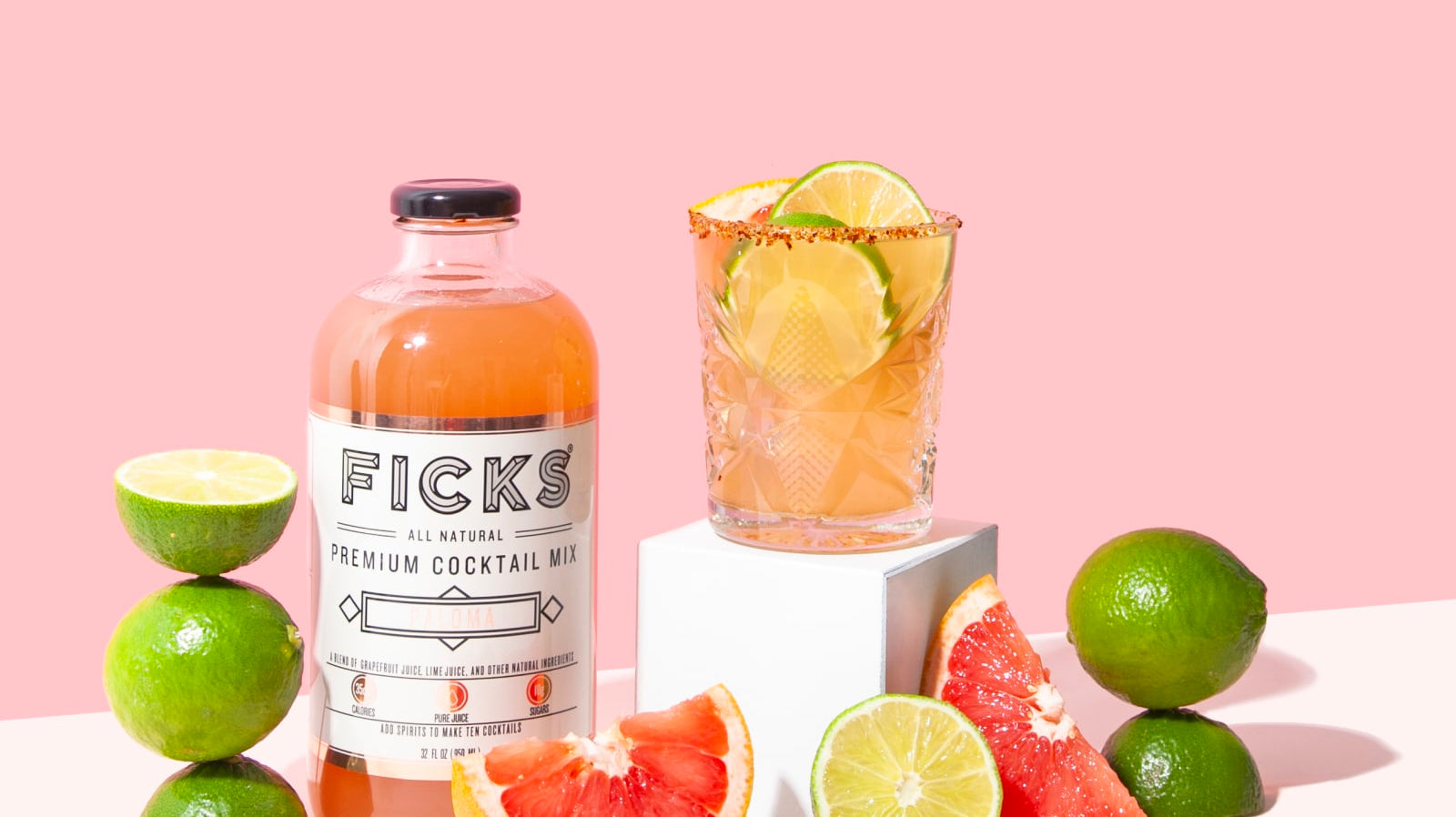 FICKS Paloma Cocktail Mixer with grapefruit wedges and Paloma cocktail in glass